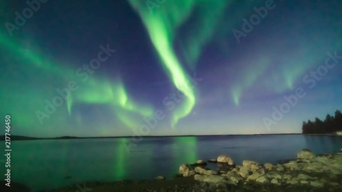 Timelapse of the Aurora Borealis over the Bay of Bothnia in Sweden's High Coast region. The foreground is lit by the full moon photo