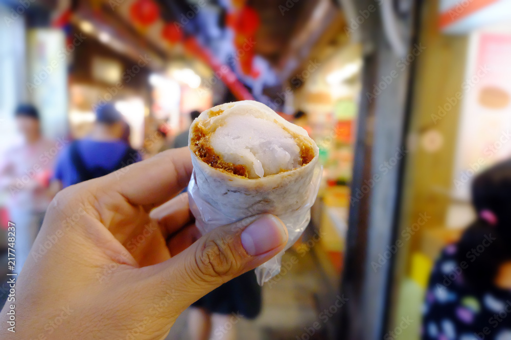 Hand holding peanut roll Ice cream, dessert of Jin Feng, Ruifang, Taiwan. Hand holding peanut roll Ice cream, dessert of Jin Feng, Ruifang, Taiwan.