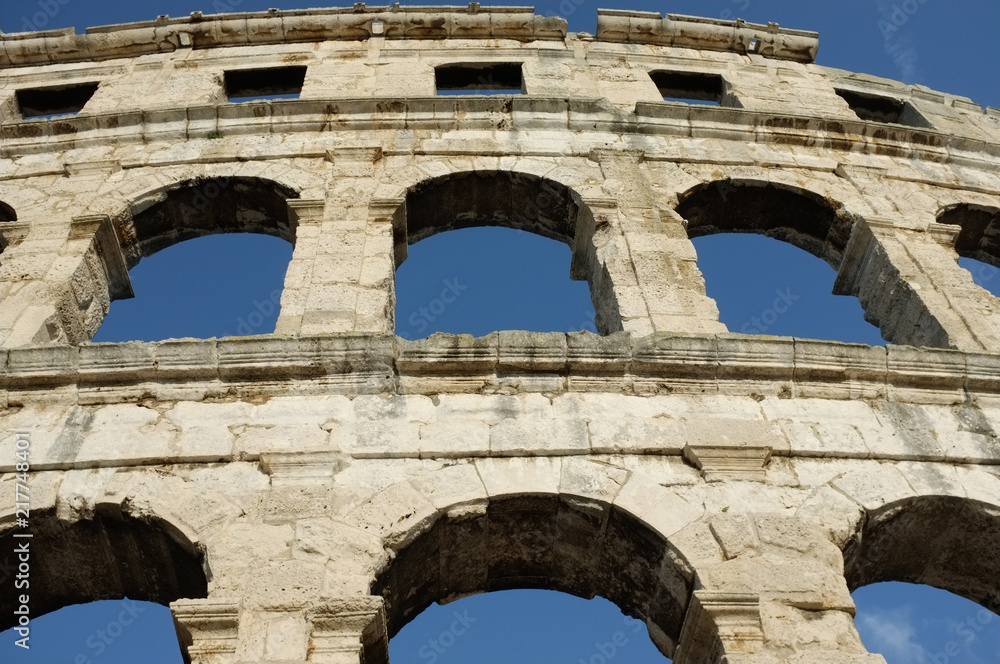 The detail of Arena Pula with cloudy sky in the background