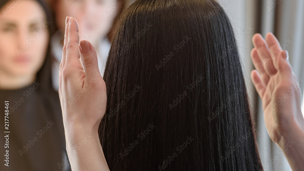 Fototapeta premium Female barber showing woman her new hairstyle