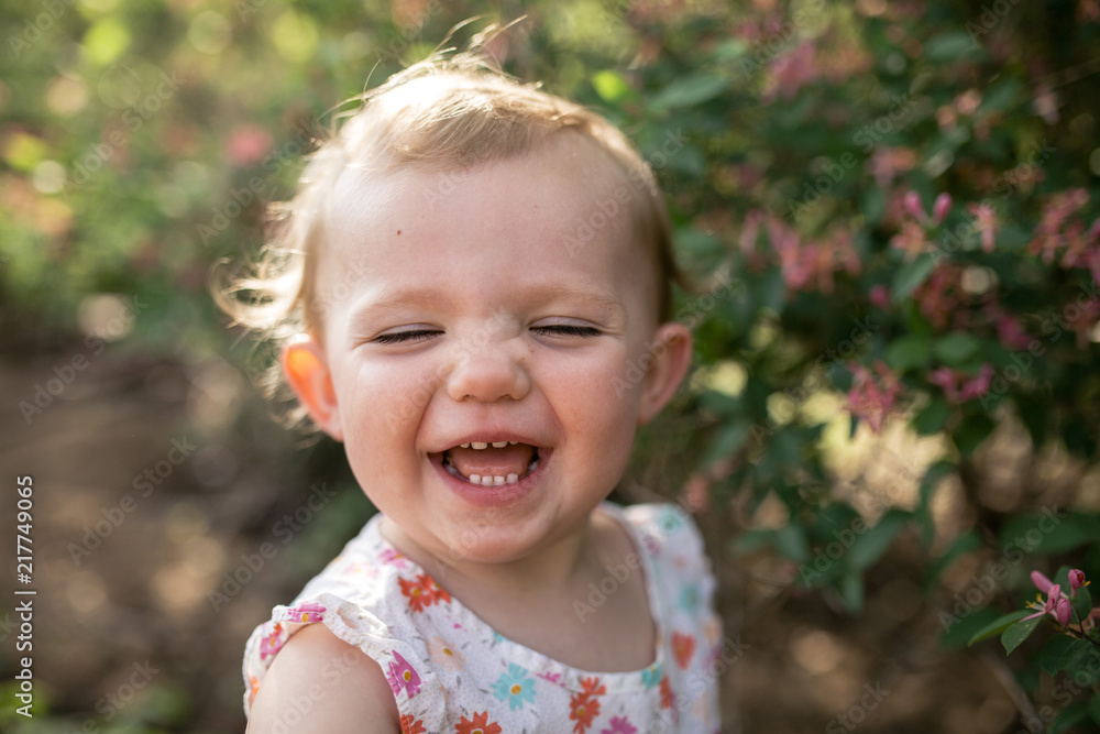 Close-up of happy baby girl standing against plants at park Close-up of happy baby girl standing against plants at park