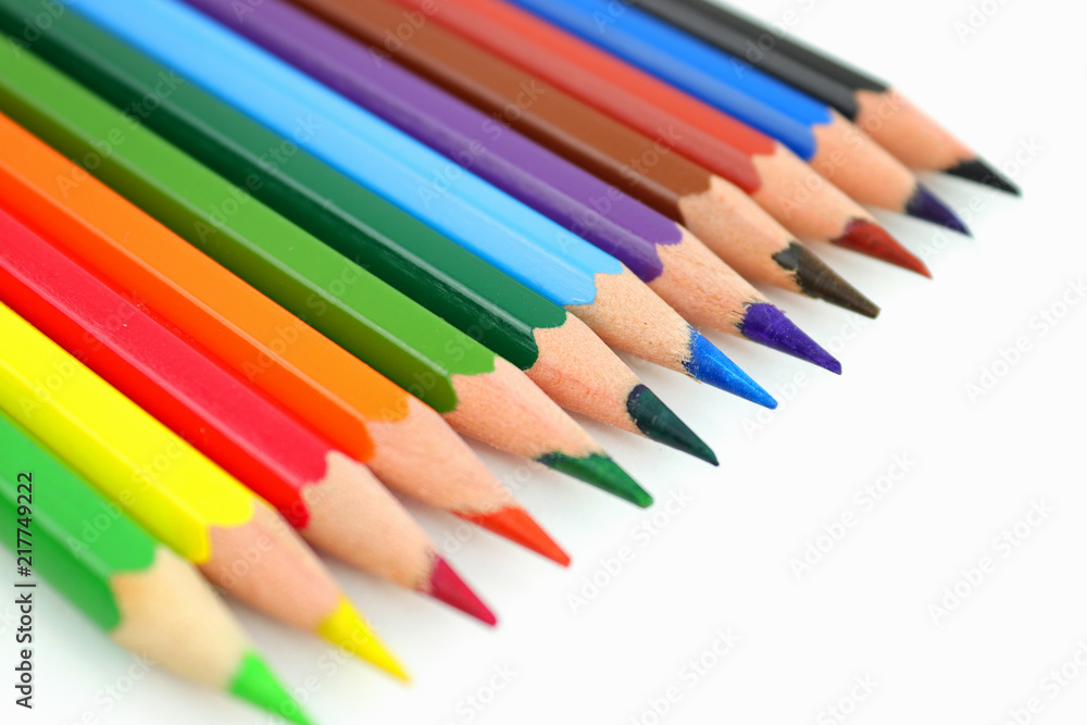 Row of colored pencils on a white background