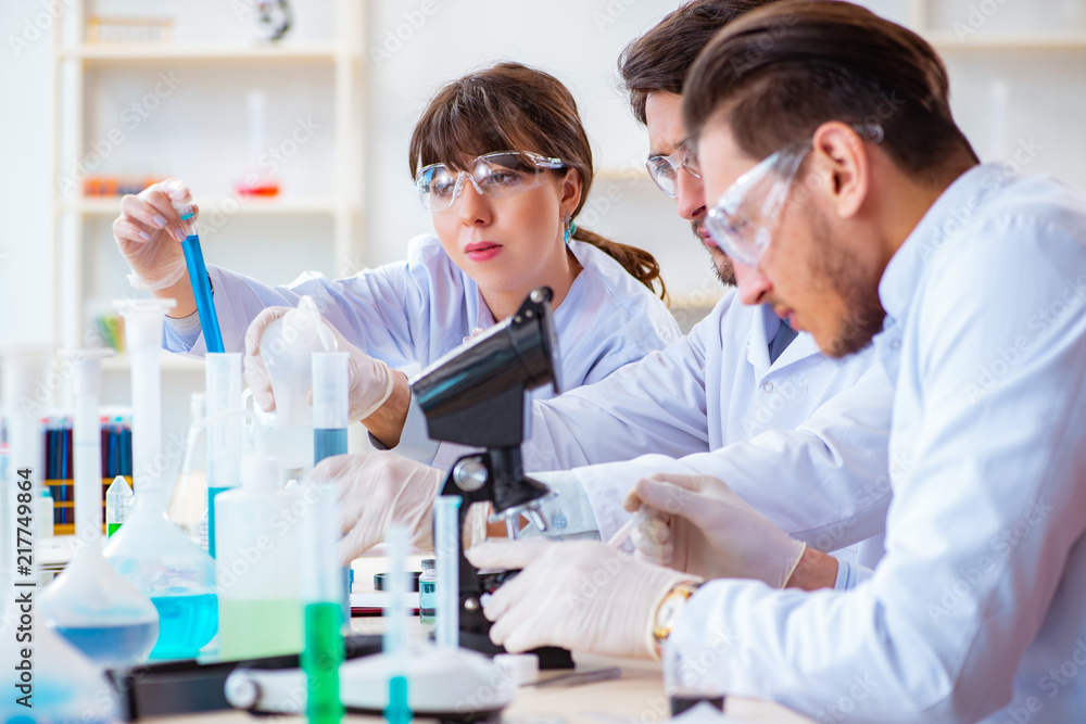 Team of chemists working in the lab Team of chemists working in the lab