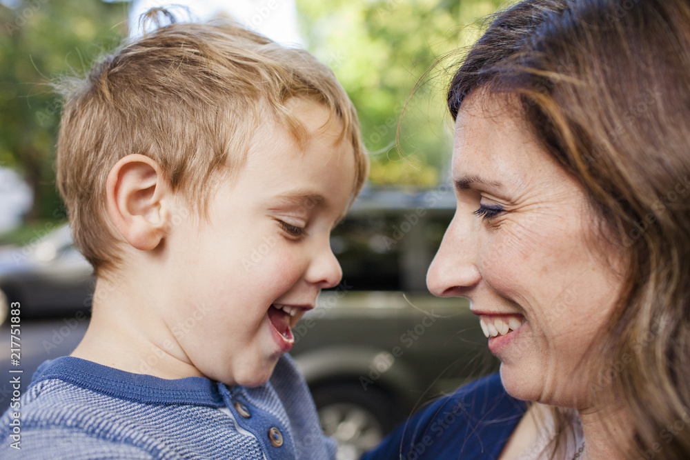 Close-up of happy mother looking at cute son while standing outdoors Close-up of happy mother looking at cute son while standing outdoors