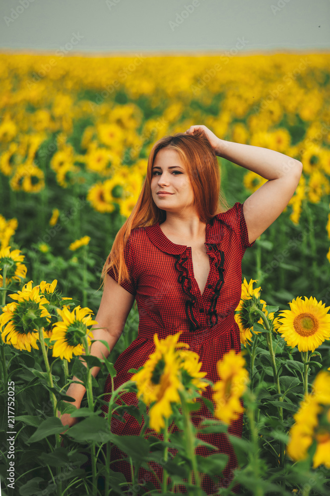 Beautiful girl in a huge yellow field of sunflowers. Beautiful girl in a huge yellow field of sunflowers.