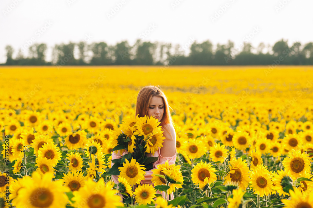 Beautiful girl in a huge yellow field of sunflowers. Beautiful girl in a huge yellow field of sunflowers.