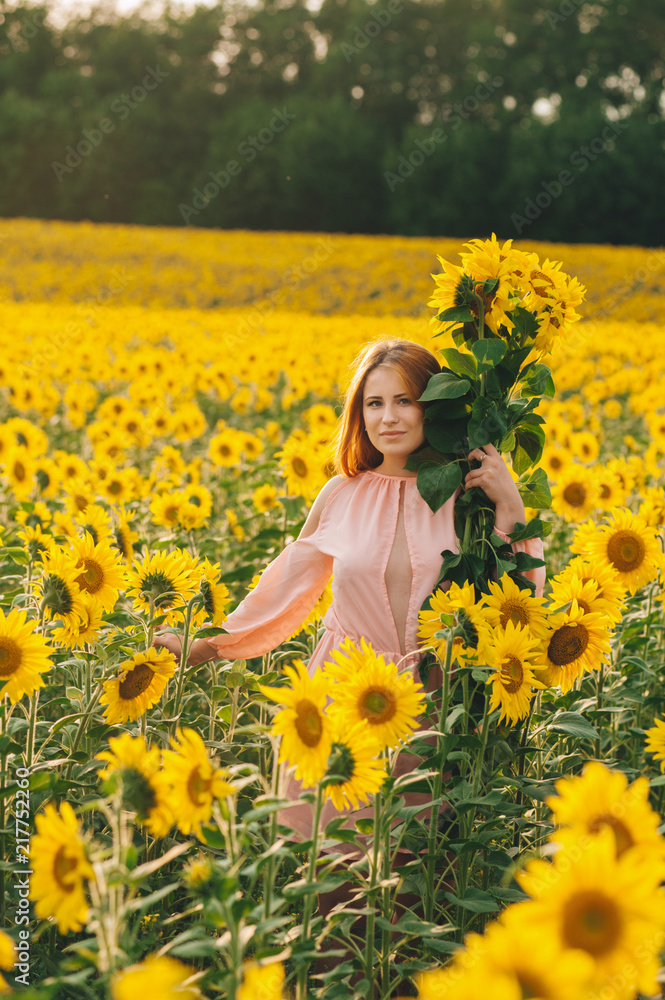 Beautiful girl in a huge yellow field of sunflowers. Beautiful girl in a huge yellow field of sunflowers.