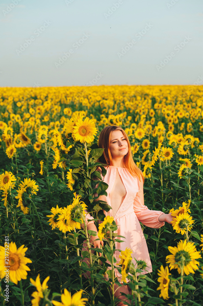 Beautiful girl in a huge yellow field of sunflowers. Beautiful girl in a huge yellow field of sunflowers.