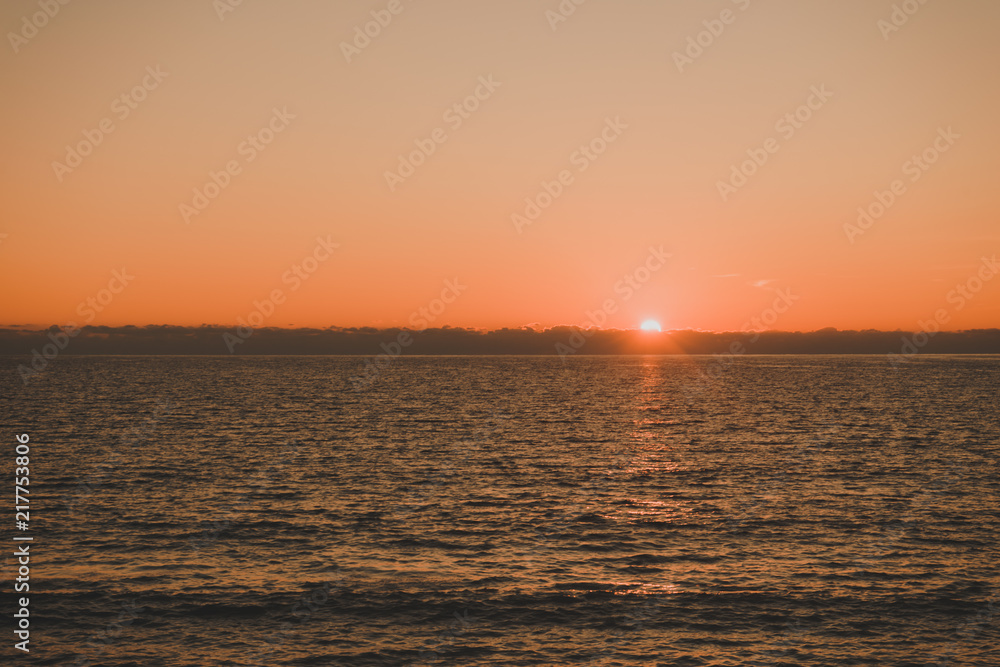 Sunset or sunrise over sea surface