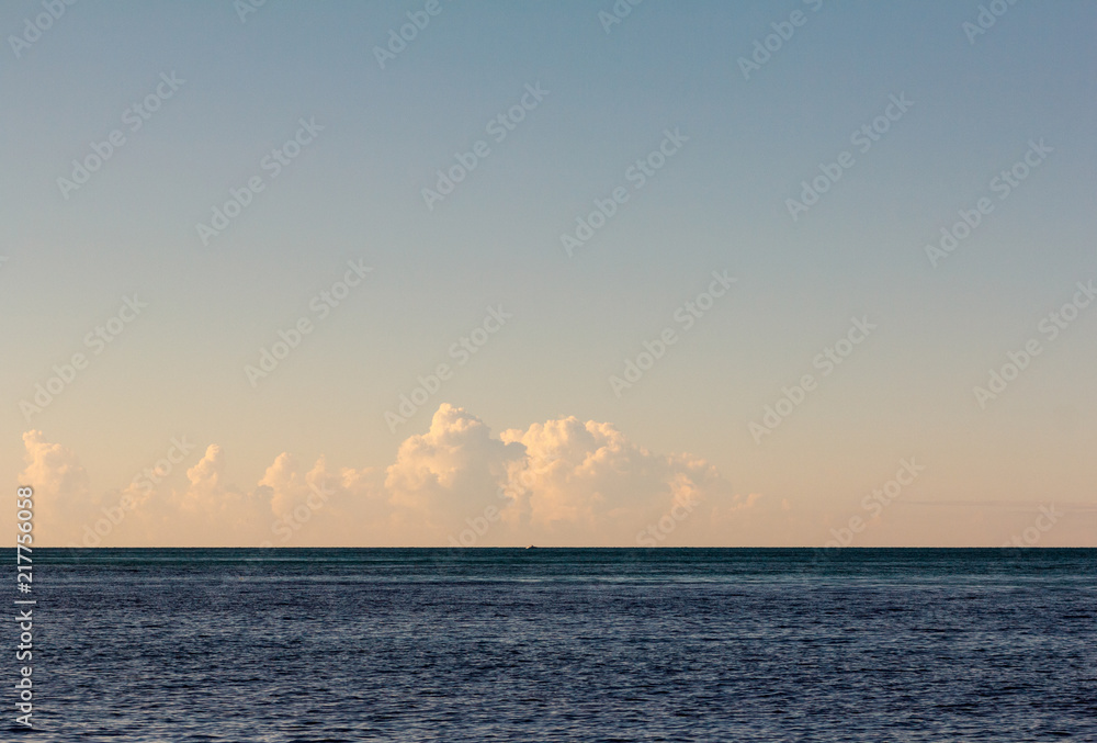 Sunrise bronze clouds at blue blue sea