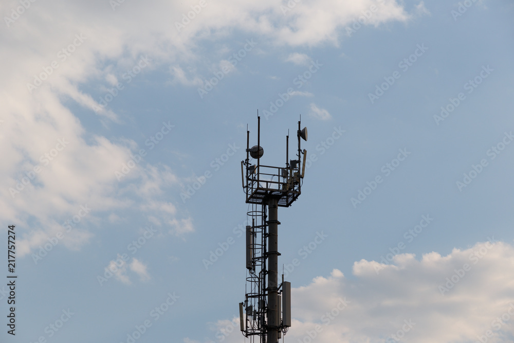 Telecommunications tower with blue sky and clouds Telecommunications tower with blue sky and clouds