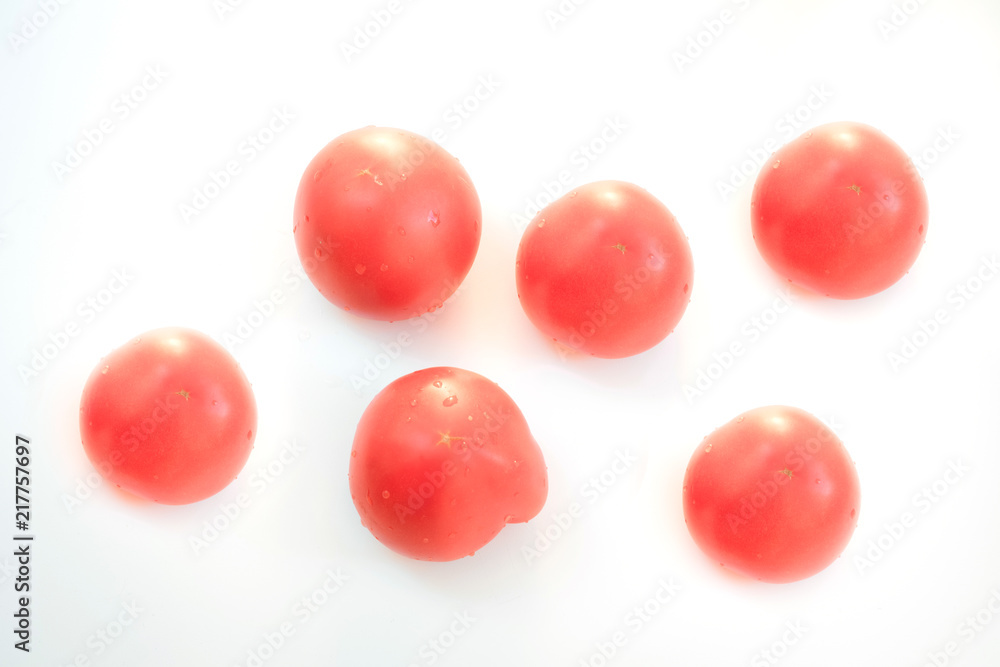 Red tomatoes on a white background. Red tomatoes on a white background.
