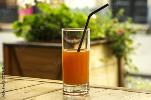 Fresh orange juice with mint in a glass bowl on a dark plate. Orange juice on a dark background  top view  copy space.