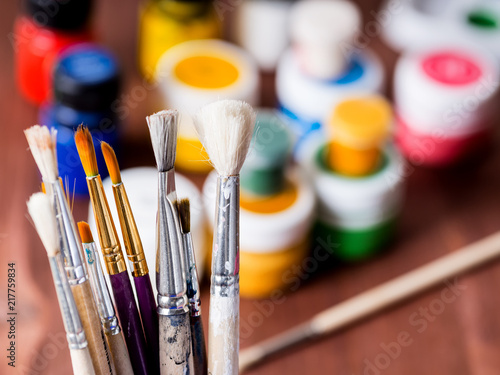 Artistic brushes in a cup closeup