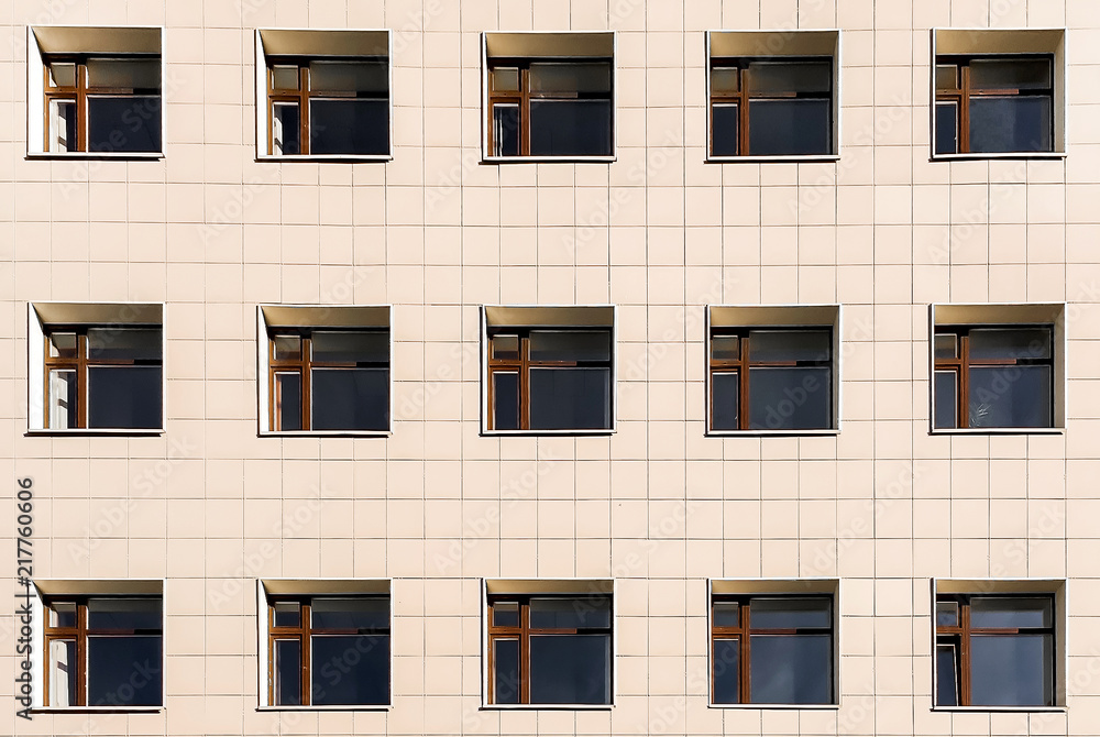 Square Windows of the building on a yellow background, lots of Windows