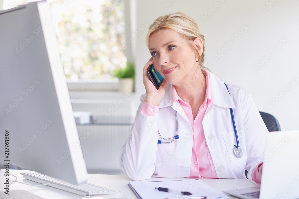 Female doctor consulting with her patient on mobile phone Female doctor consulting with her patient on mobile phone