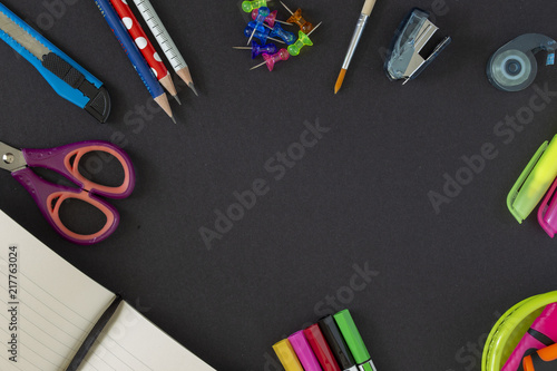 Back to school supplies on dark background. Still life. Copy space.