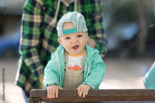cute baby boy in a cap and jacket. outdoor portrait
