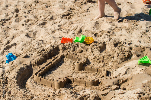 travel background with waves of sea children toys in the sand castles