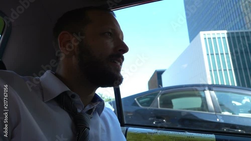 Wallpaper Mural Young handsome businessman riding taxi through city, super slow motion
 Torontodigital.ca