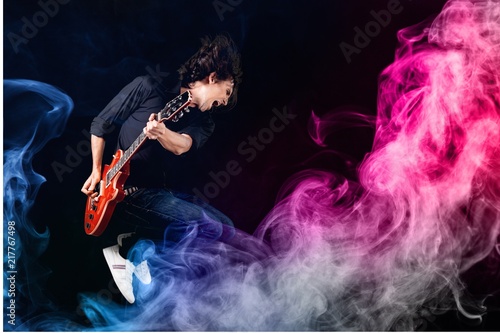 Musician Jumping and color smoke © BillionPhotos.com