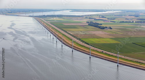 Quadro em tela Aerial view row offshore wind turbines along coast and dike of Flevoland, The Ne
