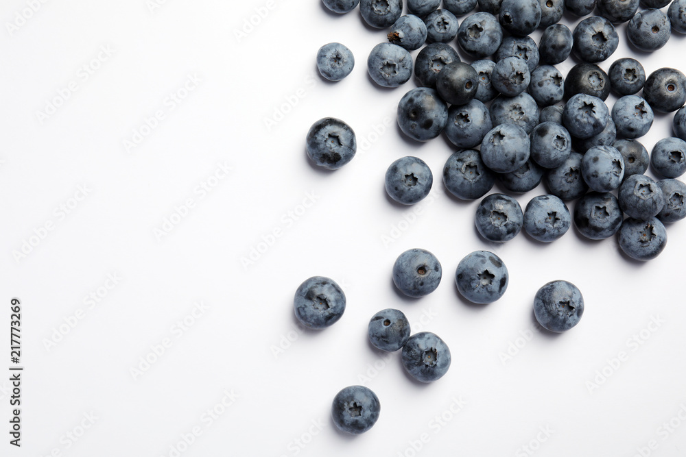 Flat lay composition with tasty blueberry and space for text on white background Flat lay composition with tasty blueberry and space for text on white background