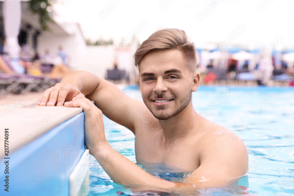 Young man in pool on sunny day