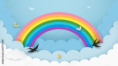 Layered cloudscape background with rainbow, flying birds and butterflies. Fluffy clouds in the sky. Kids room, baby nursery wallpaper. Minimal paper art design. Vector Illustration.