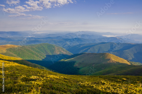 View from the top of the mountain to the remote mountains and valleys. Summer mountain landscape