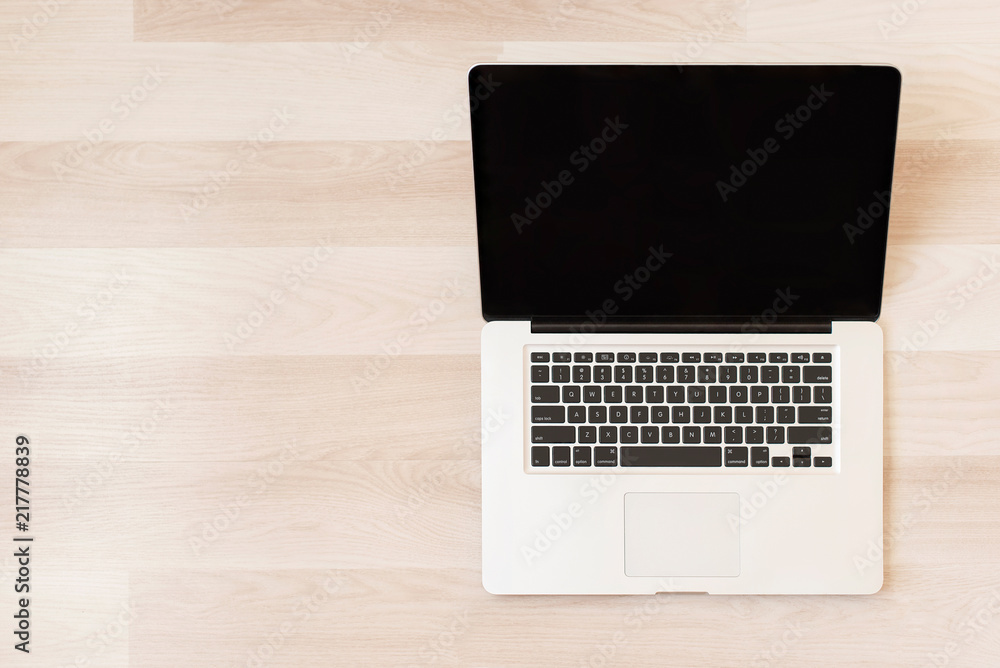 Laptop on wooden background. Business template mock up for adding your text. Minimal style. Flat lay, top view. Laptop on wooden background. Business template mock up for adding your text. Minimal style. Flat lay, top view.