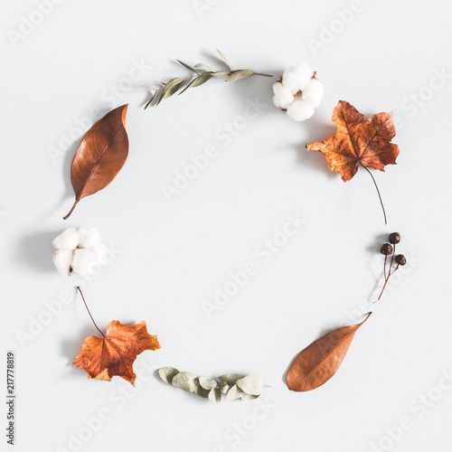 Autumn composition. Wreath made of eucalyptus branches, cotton flowers, dried leaves on pastel gray background. Autumn, fall concept. Flat lay, top view, copy space, square