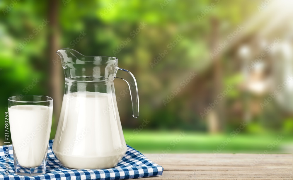 Glass of milk and bottle on  background