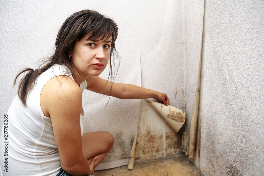 Fotografie A girl removing Mold fungus without respirator mask
