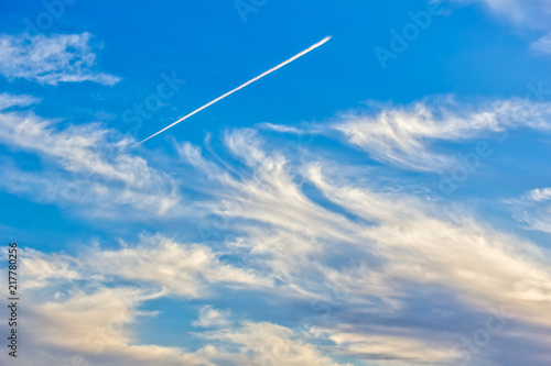 Blue sky with light white cirrus clouds at sunset