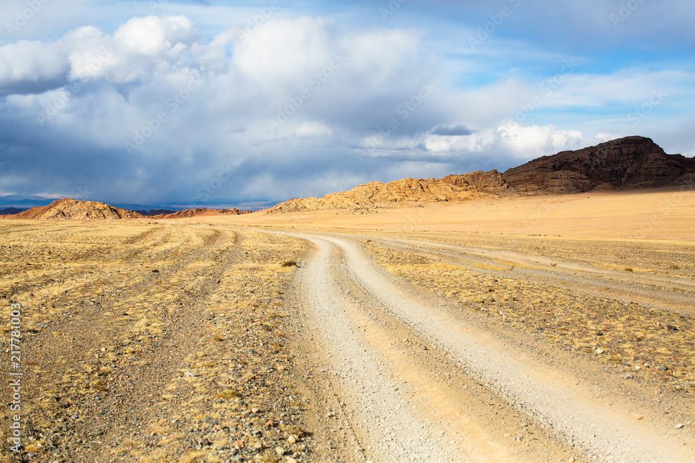 Landscape of a road through the steppe and mountains in Western Mongolia.