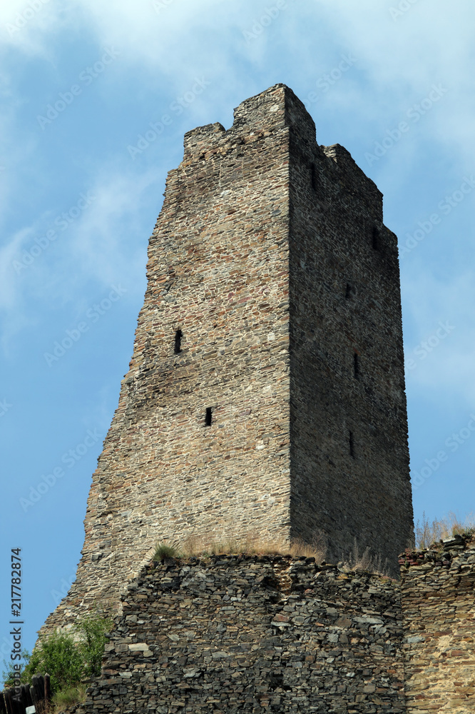 Okor Castle Tower with blue summer sky as backdrop