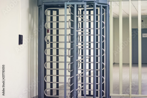 Entrance through big in full human growth steel turnstiles. Concept of security with electronic pass