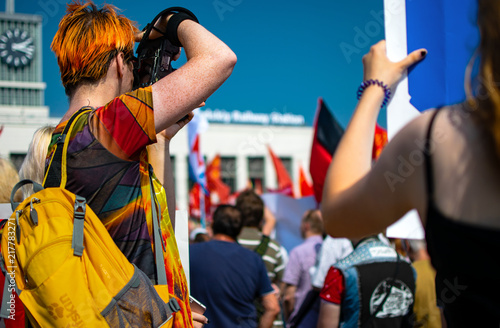 Photographer takes a photoes at a protest rally