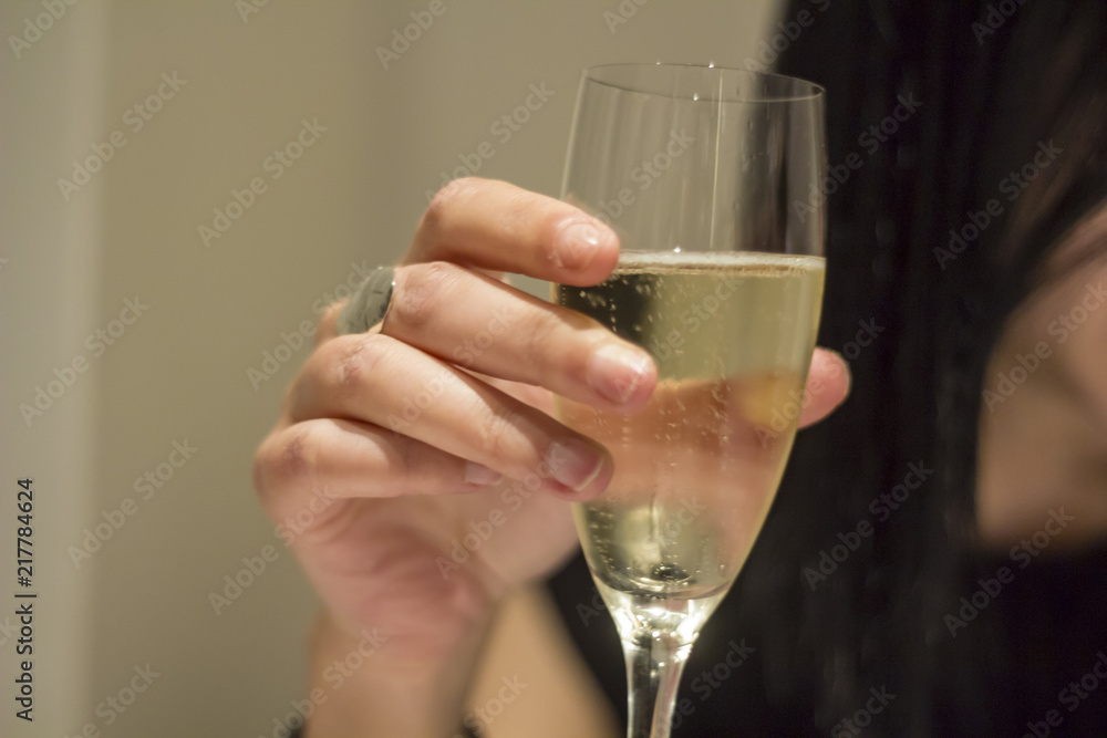 Woman hand holding a glass with Italian sparkling Prosecco wine