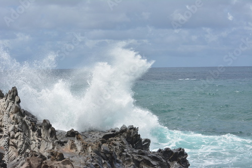 Wave crashing against the rocky coastline of Maui, Hawaii