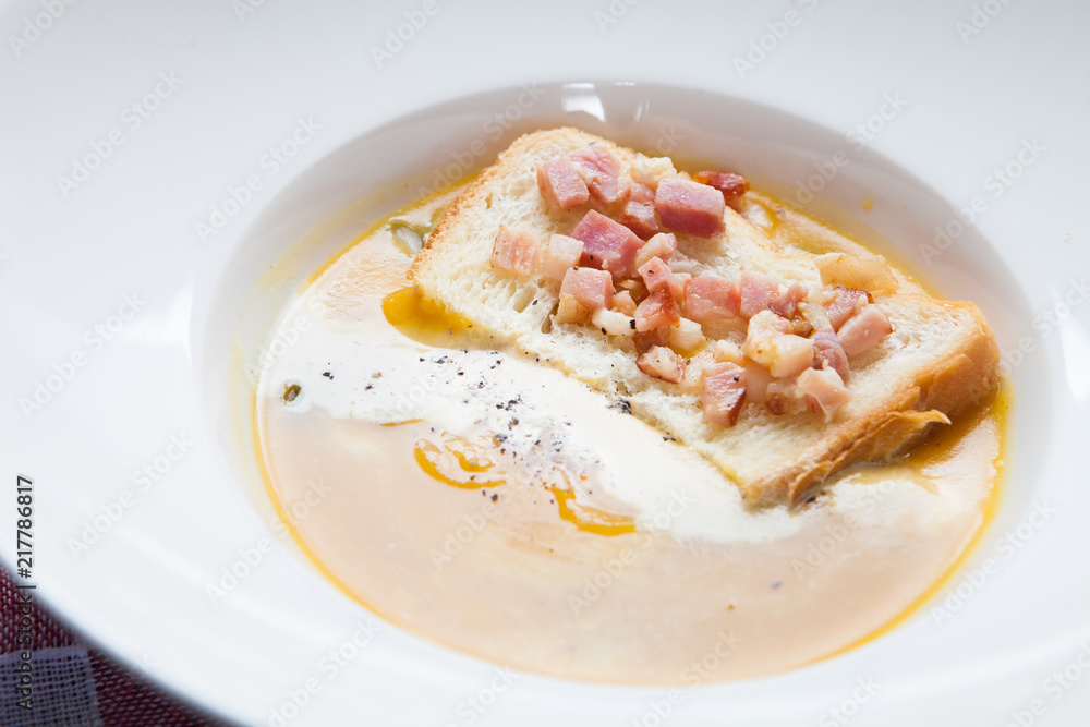 Pumpkin cream soup with white bread toast with bacon Pumpkin cream soup with white bread toast with bacon
