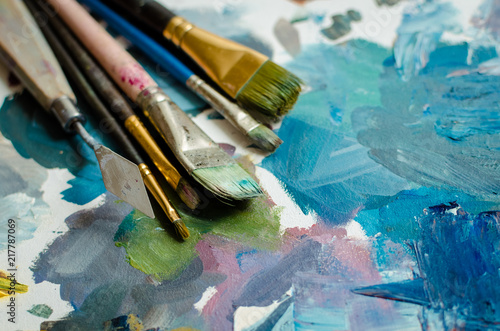 Artist paint brushes on the wooden palette