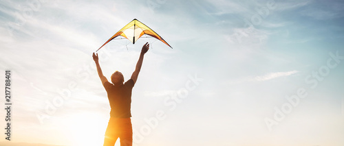 Man start to fly a kite in the sky photo