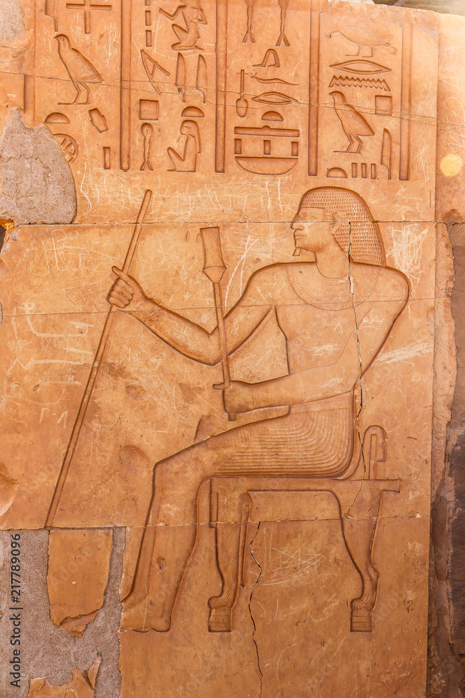 stone wall with Egyptian carving figures and hieroglyphs, Aswan, Egypt, Africa. stone wall with Egyptian carving figures and hieroglyphs, Aswan, Egypt, Africa.