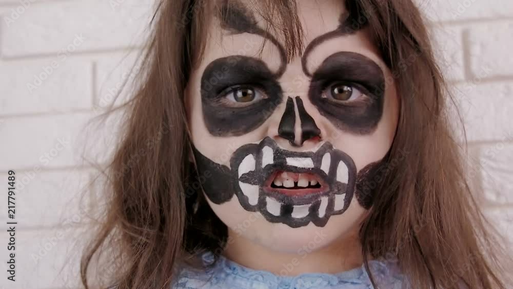 A terrible child. Child With a painted face scares. A terrible child. Child With a painted face scares.