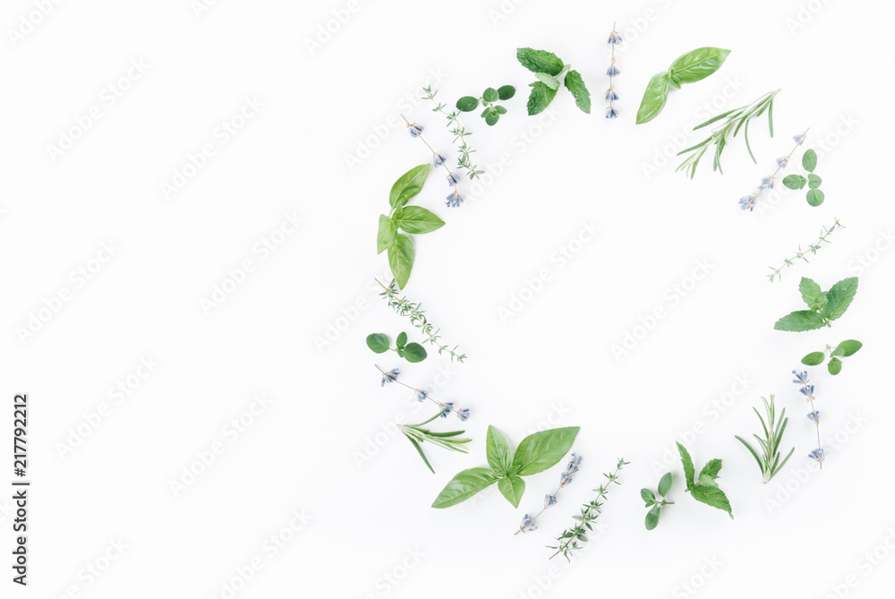 essential oils with botles and herbs on white background