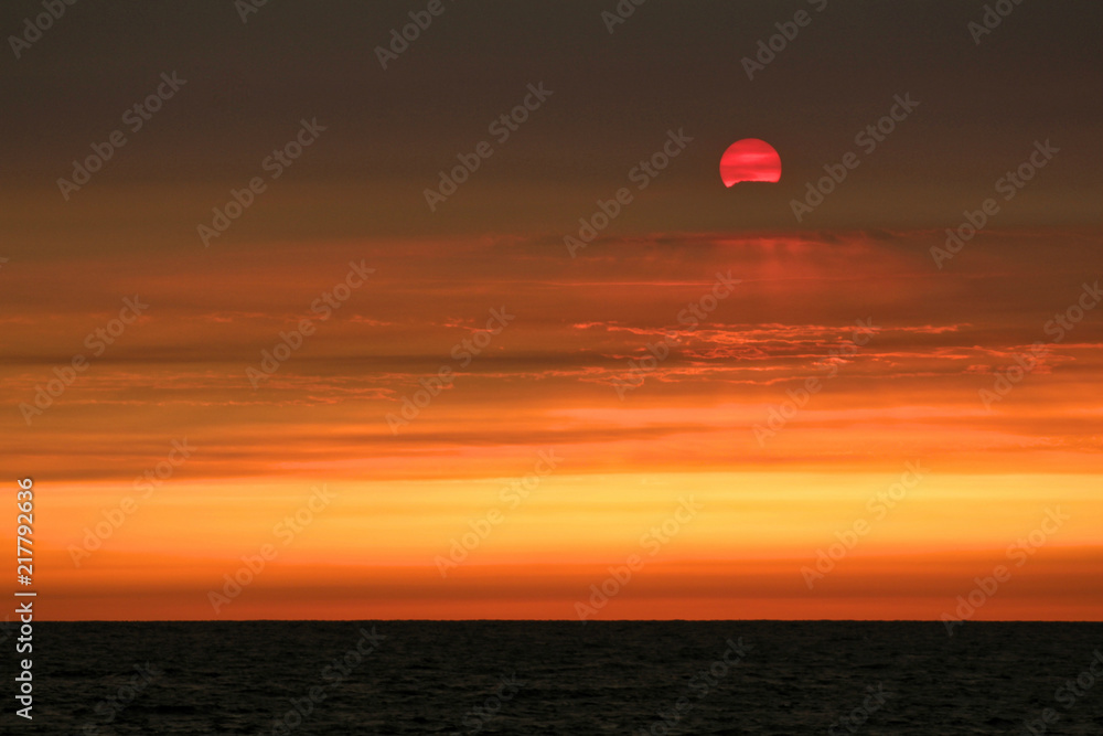 Dramatic Sunset over the Pacific Ocean Caused by Wildfire Smoke