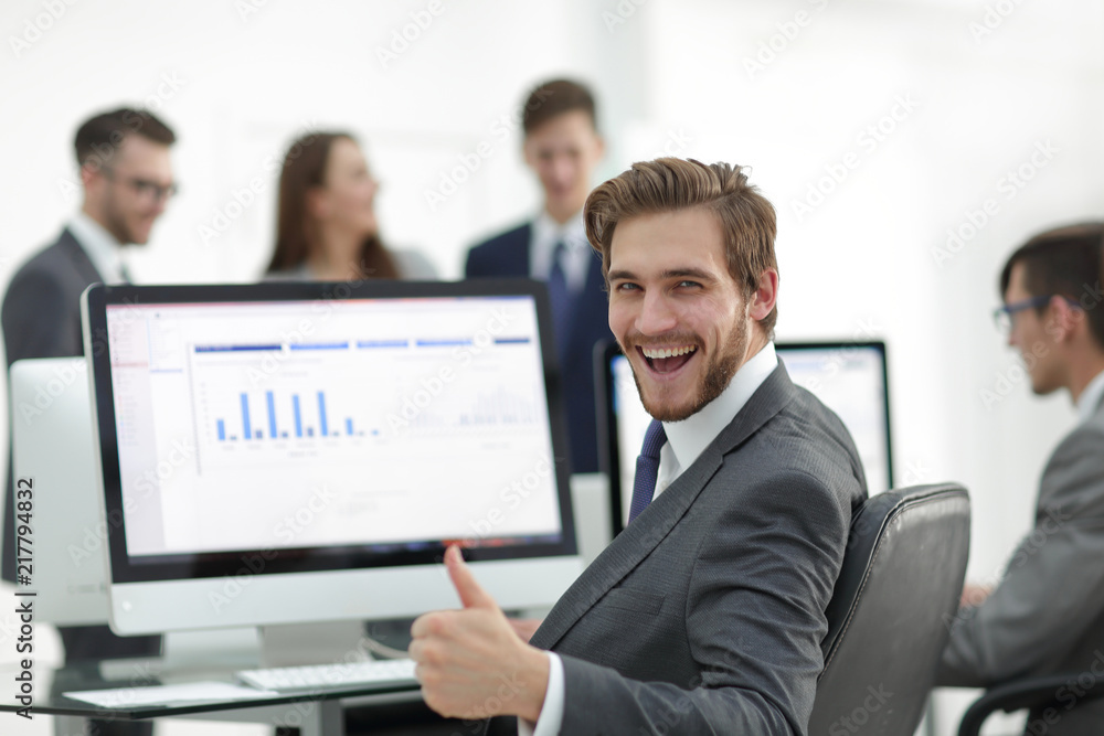 Successful business man with a thumb up in the office Successful business man with a thumb up in the office