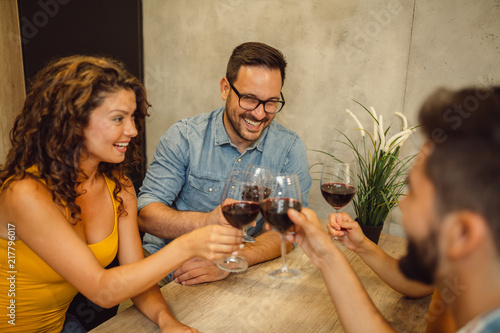 Group of friends are having fun with glasses of wine